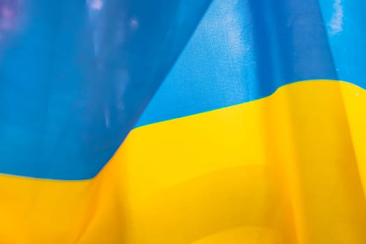 Flag of Ukraine, UA. Blue and yellow colors. Close up shot, background
