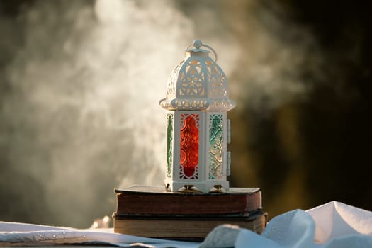 Ramadan Kareem background. Ornamental Arabic lantern glowing at night and the Quaran.