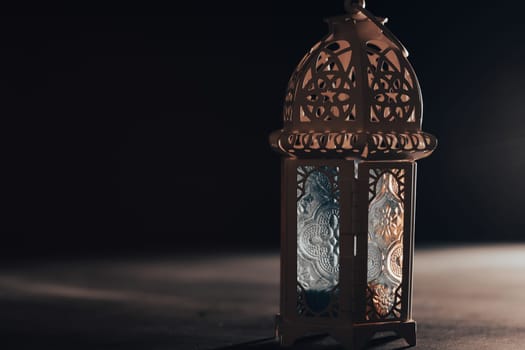 Ramadan Kareem background. Ornamental Arabic lantern glowing at night