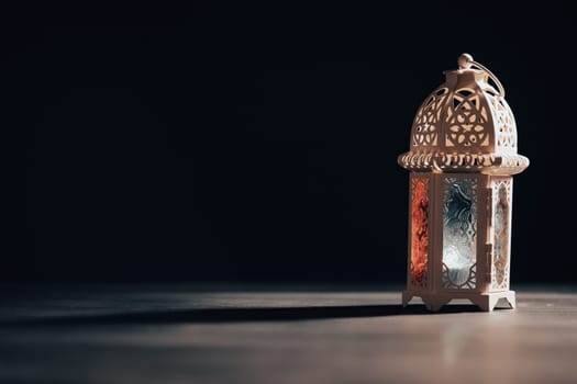 Ramadan Kareem background. Ornamental Arabic lantern glowing at night