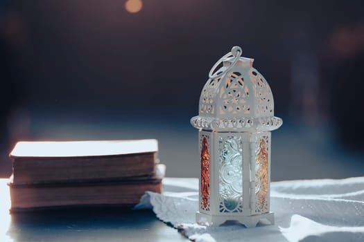 Ramadan Kareem background. Ornamental Arabic lantern glowing at night and the Quaran.
