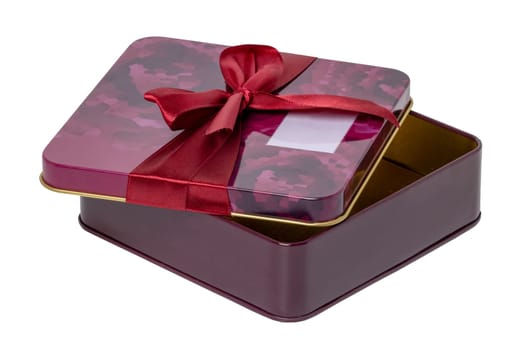 Closeup of a decorative red pink present or gift box with ribbon bow isolated on a white background. Birthday, Christmas, Valentine's Day. Clipping path. Macro.