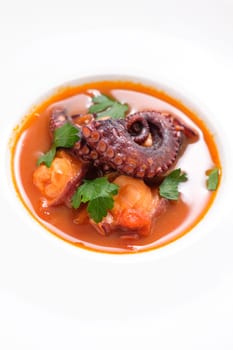 Stewed octopus and tomato with parsley in a restaurant