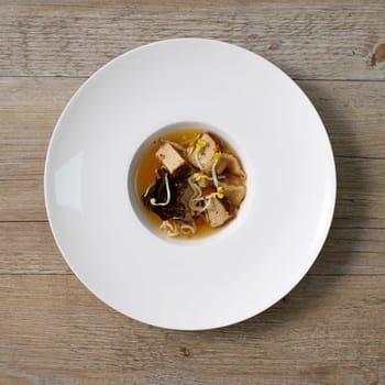 Japanese ramen sou in a plateon wooden table