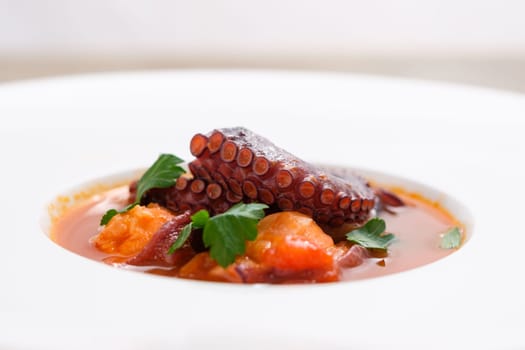 Octopus with tomato and parsley dish in a restaurant