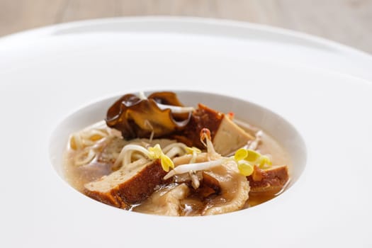 Ramen soup with tofu sprouts and mushrooms in a restaurant