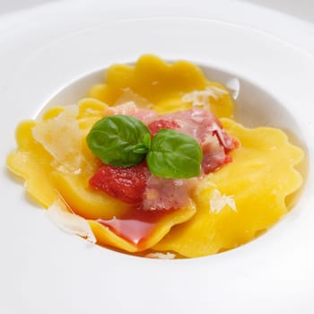 Tortellini with red tomato sauce parmesan cheese and basil