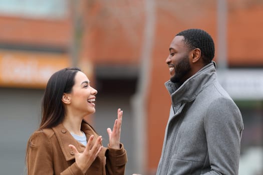 Interracial relation with woman and man talking in the street