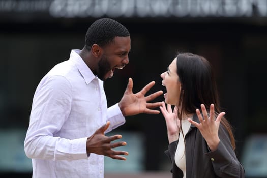 Interracial couple arguing in the street