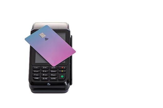 the plastic card lies on the payment terminal with a white isolated background. High quality photo
