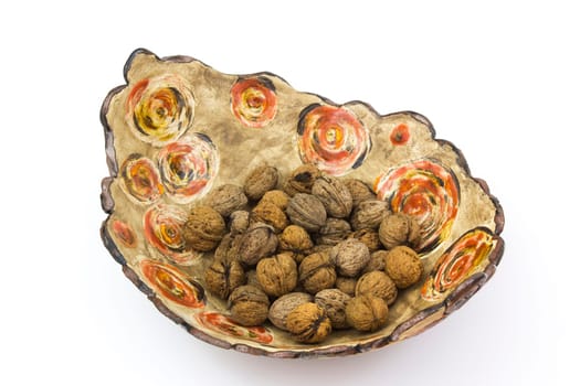 walnuts in a clay pot - white background
