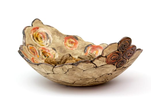 walnuts in a clay pot - white background