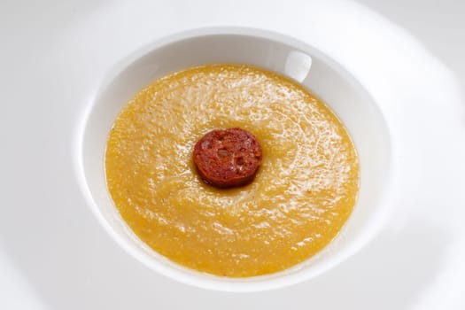 Italien polenta with parmesan cheese and chorizo sausage close-up
