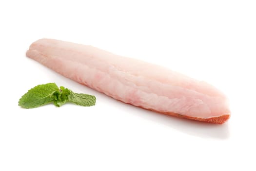 Redfisch filet with green mint leaves on white isolated
