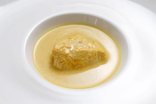 Spicy chicken curry with coconut milk in a plate