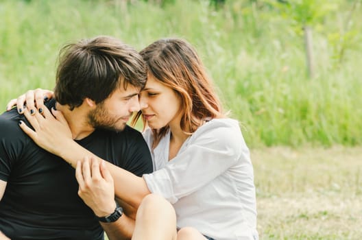 Happy couple hugging in nature