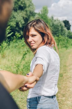 Young couple holding hands and hiking