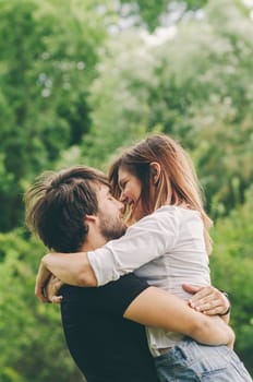 Happy couple hugging in nature