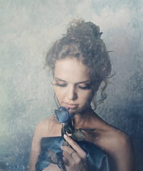 Beautiful female portrait with blue rose