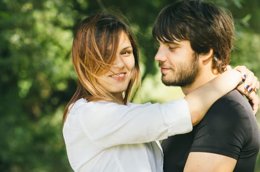 Happy couple hugging in nature