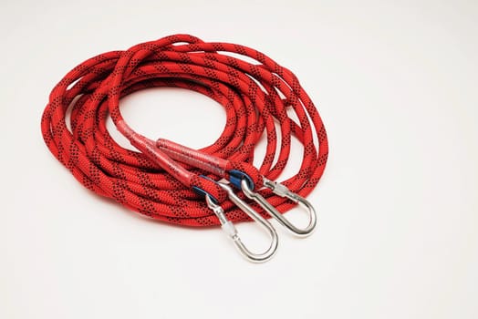 Red climbing rope on white background