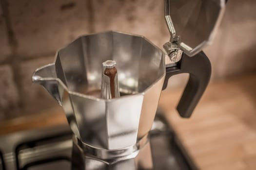 Classic Stovetop or Moka Pot Espresso Maker brewing coffee. Close-up and selective focus.