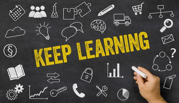 Keep learning written on a blackboard with icons