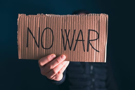 Man holding placard No war text. Freedom to Ukraine concept.