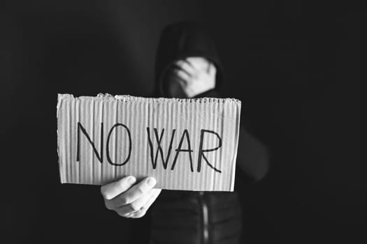 Man holding placard No war text. Freedom to Ukraine concept.