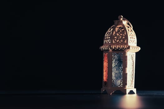 Ramadan Kareem background. Ornamental Arabic lantern glowing at night