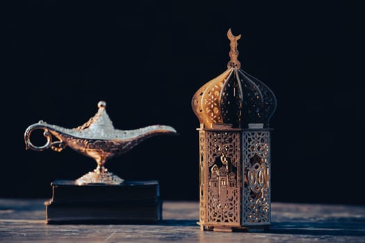 Ramadan Kareem background. Aladdin lapm, Quran and ornamental Arabic lantern glowing at night