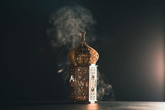 Ramadan Kareem background. Ornamental Arabic lantern glowing at night