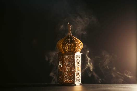 Ramadan Kareem background. Ornamental Arabic lantern glowing at night