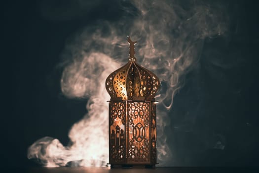 Ramadan Kareem background. Ornamental Arabic lantern glowing at night
