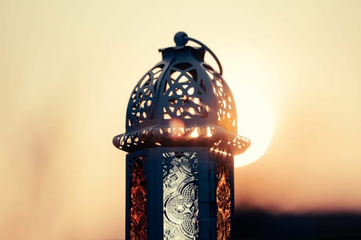 Ramadan Kareem background. Ornamental Arabic lantern in the sunset