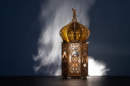 Ramadan Kareem background. Ornamental Arabic lantern glowing at night