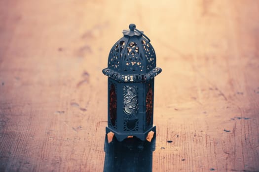 Ramadan Kareem background. Ornamental Arabic lantern glowing at night