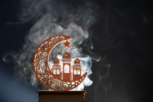Ramadan Kareem background. Ornamental Arabic lantern glowing at night
