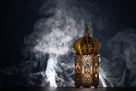 Ramadan Kareem background. Ornamental Arabic lantern glowing at night