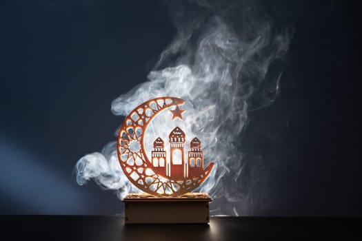 Ramadan Kareem background. Ornamental Arabic lantern glowing at night