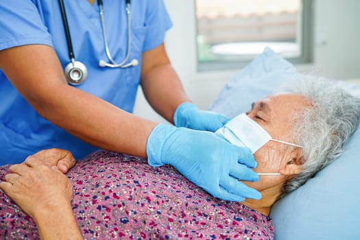 Doctor check Asian elder senior woman patient wearing a mask for protect covid coronavirus.