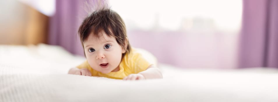 Cute little baby lying on the blanket on the bed. Concept of childhood and new life.