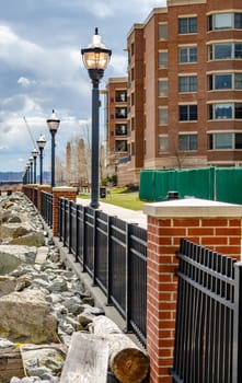 Residential Area at West New York, New Jersey, Fence with street lights at Hudson River, close-up during cloudy winter day, horizontal