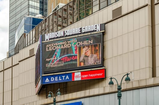 Madison Square Garden Advertisement Television Screen with An Evening with Leonard Cohen on the screen, screen installed at the Building, New York City during sunny winter day, horizontal