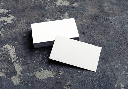 Photo of blank business cards on concrete background. Template for branding identity.