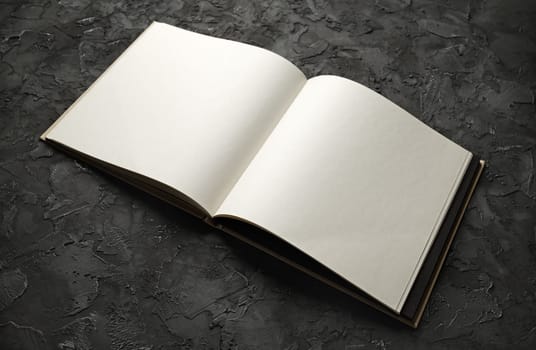 Blank booklet mock up on black plaster background.