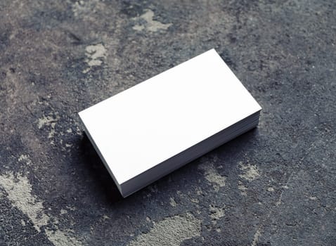 Blank white business card on concrete background. Mockup for ID. Template for graphic designers portfolios.
