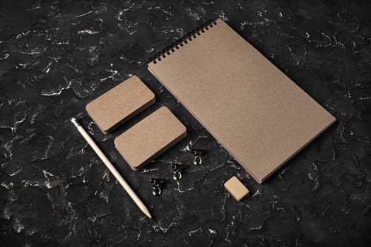 Blank kraft corporate stationery set on black plaster background. Template for branding design. Branding mock up.
