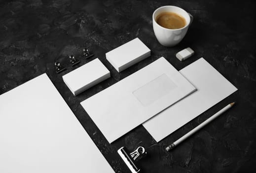 Blank stationery and corporate identity template on black plaster background. For design presentations and portfolios.
