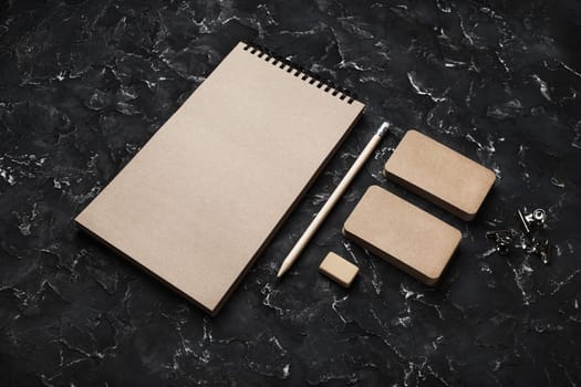 Blank kraft stationery set on black plaster background. Corporate identity template. Mock-up for branding identity for designers.